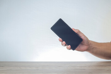 A cropped hand holding a smartphone 