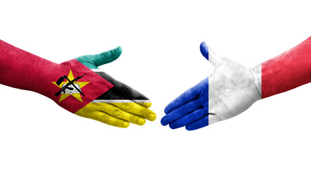 Handshake between France and Mozambique flags painted on hands, isolated transparent image.