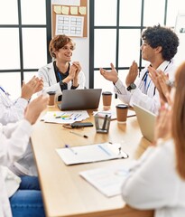 Fototapeta premium Group of doctor smiling and clapping to partner in a medical meeting at the clinic office.