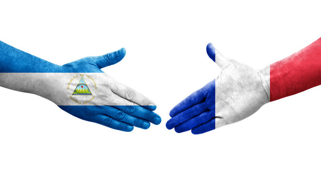 Handshake between France and Nicaragua flags painted on hands, isolated transparent image.