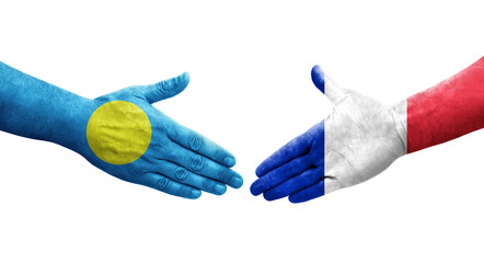 Handshake between France and Palau flags painted on hands, isolated transparent image.