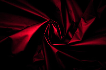 Red nylon texture. minimalist and elegant crumple textile. simple dark background