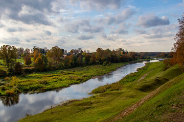 Fototapeta na wymiar Autumn landscape Memele river with colorful trees
