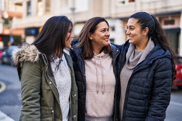 Three woman mother and daughters standing together at street