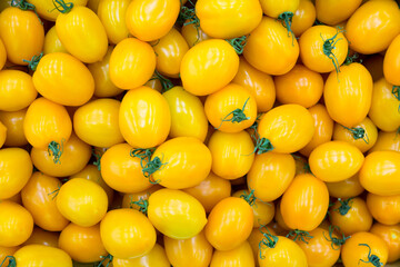 Group of fresh yellow tomatoes as a background