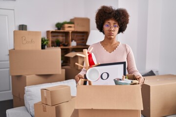 Young african american woman moving to a new home depressed and worry for distress, crying angry and afraid. sad expression.