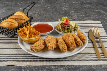Delicious crispy fried chicken breast strips served with potatoes and salads,Chicken nuggets,