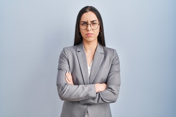 Hispanic business woman wearing glasses skeptic and nervous, disapproving expression on face with...