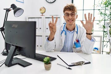 Young caucasian doctor man working at the clinic showing and pointing up with fingers number seven...