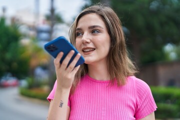 Young woman smiling confident talking on the smartphone at park