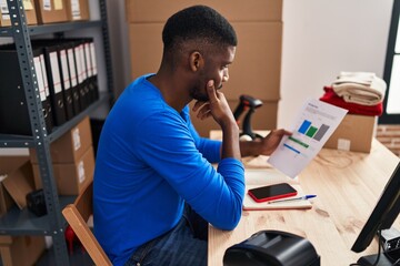 Young african american man ecommerce business worker worried reading document at office - obrazy, fototapety, plakaty