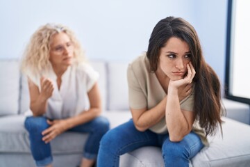 Two women mother and daughter arguing at home