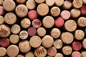 Obraz na płótnie Canvas Many wine corks with different dates as background, top view