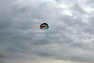Skydiver enjoys a cloudy sky over the ocean	