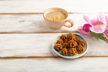 Homemade soft caramel fudge candies on white wooden, side view, copy space.