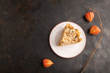 Traditional lithuanian cake shakotis on black, top view, copy space.