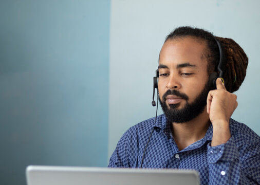 Serius businessman with headset interacting in his home office
