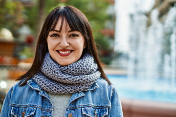 Young brunette woman smiling happy at the park