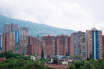 Several Brick Buildings Together Surrounded by the Mountains on an Overcast Day