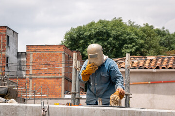 Worker Wearing a Welder's Mask on the Construction of the New Roadway