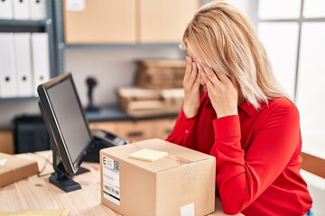 Young blonde woman ecommerce business worker stressed working at office