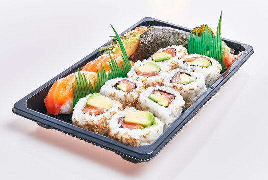  Delivery tray of delicious sushi over isolated white background