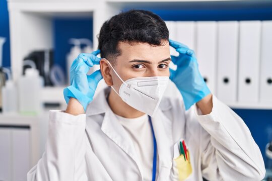 Young Non Binary Man Scientist Wearing Medical Mask At Laboratory