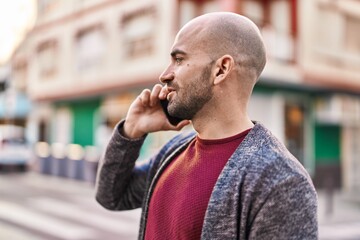 Young man talking on the smartphone at street