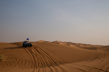 quad bike in sand dunes of desert