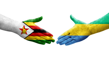 Handshake between Gabon and Zimbabwe flags painted on hands, isolated transparent image.