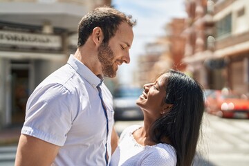 Man and woman interracial couple standing together at street