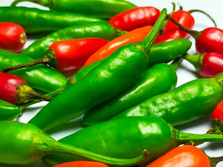 Mixed chilli pile
isolated on a white background. Mixed chili background.
