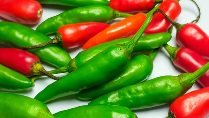 Mixed chilli pile
isolated on a white background. Mixed chili background.