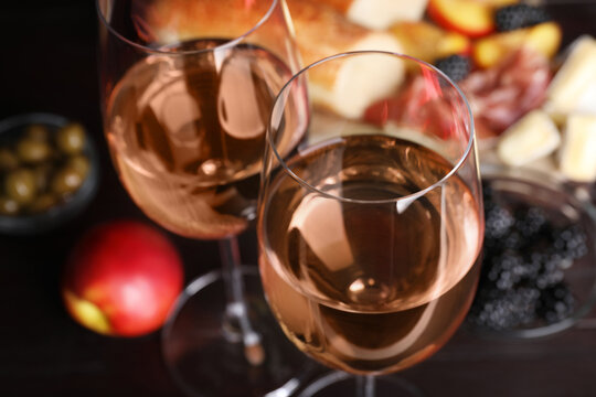 Glasses of delicious rose wine on table, closeup