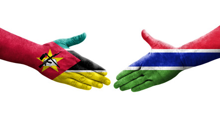 Handshake between Gambia and Mozambique flags painted on hands, isolated transparent image.