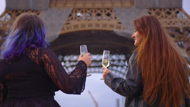 Two teen girls friends siblings couple recording trendy dance moves for posting in internet social media account in Paris. Modern communication and gadgets