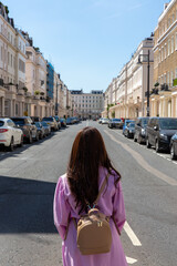 girl walking on london street in belgravia district