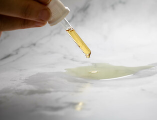 Almond oil being poured into water on a white background from a meter. Used in skin and body hydration and in a beauty spa for relaxation and massages in natural spaces providing well-being.