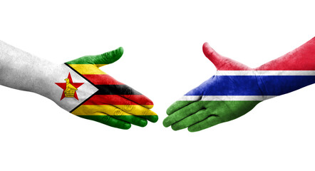 Handshake between Gambia and Zimbabwe flags painted on hands, isolated transparent image.