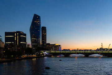 london skyline at sunset along the thames river