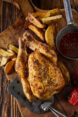 Chicken and potatoes near sauce