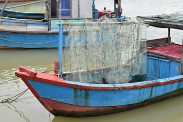 Fototapeta na wymiar Blue old fishing ship with nets for catching crabs.