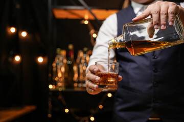 Barman pouring whiskey whiskey glass beautiful night