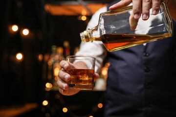 Barman pouring whiskey whiskey glass beautiful night