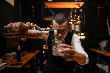 Barman pouring whiskey whiskey glass beautiful night