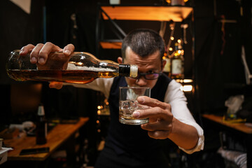 Barman pouring whiskey whiskey glass beautiful night
