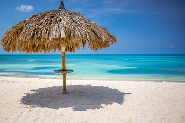 Aruba idyllic caribbean beach at sunny day with rustic palapa, Dutch Antilles