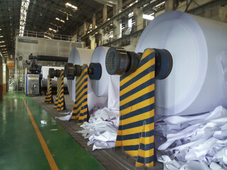 Kolkata, West Bengal, India - 16th May 2019 : White Paper Reels are being manufactured in a big paper manufacturing plant. Indian paper industry is growing.