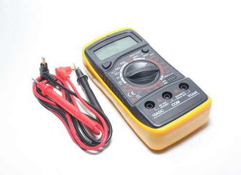 Digital multimeter with probes and display on a white background