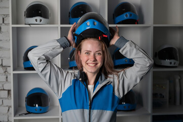 Caucasian woman puts on a helmet before flying in a wind tunnel. Free fall simulator.
